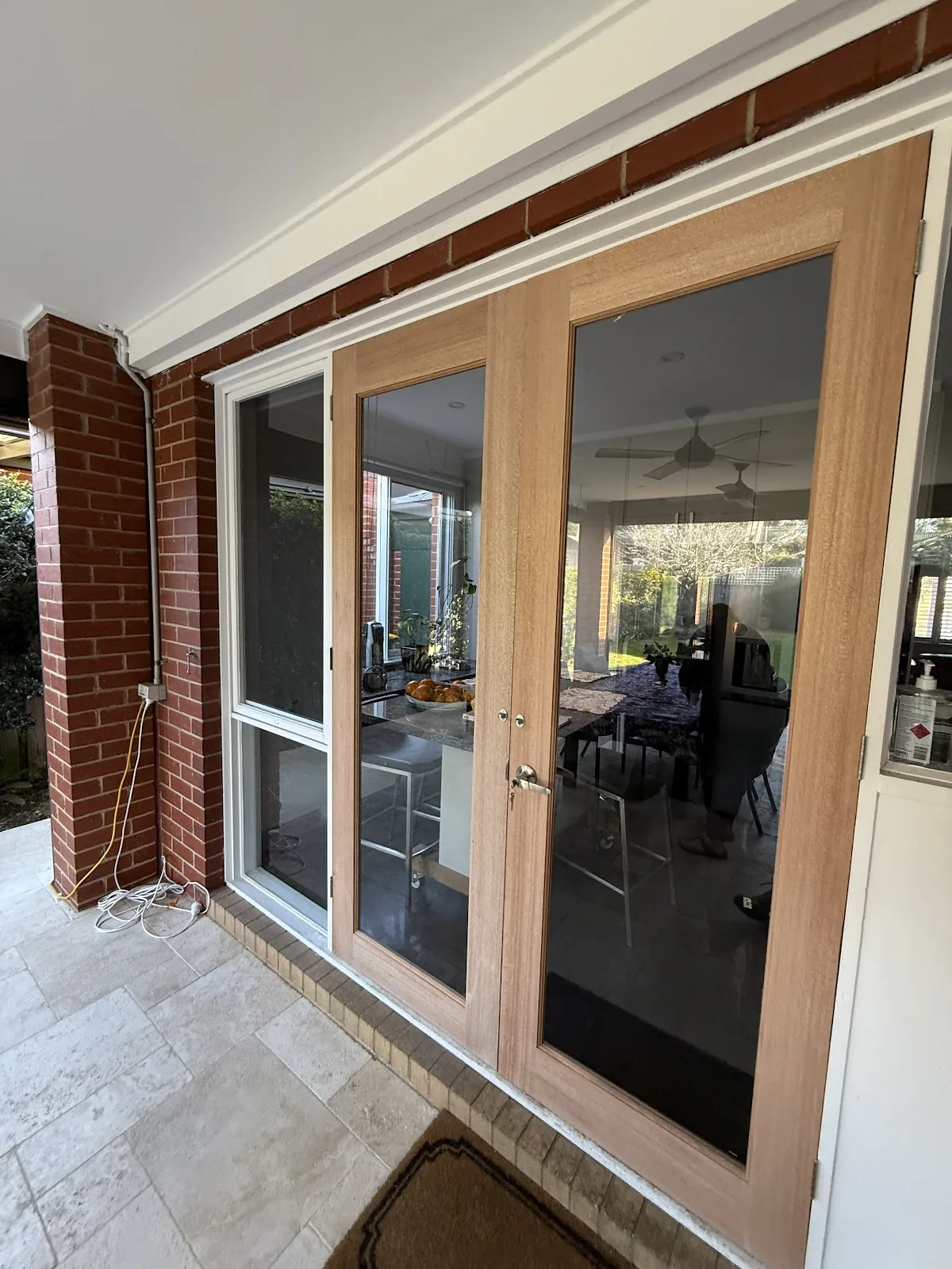 Custom timber-look French doors with security screens installed in Melbourne